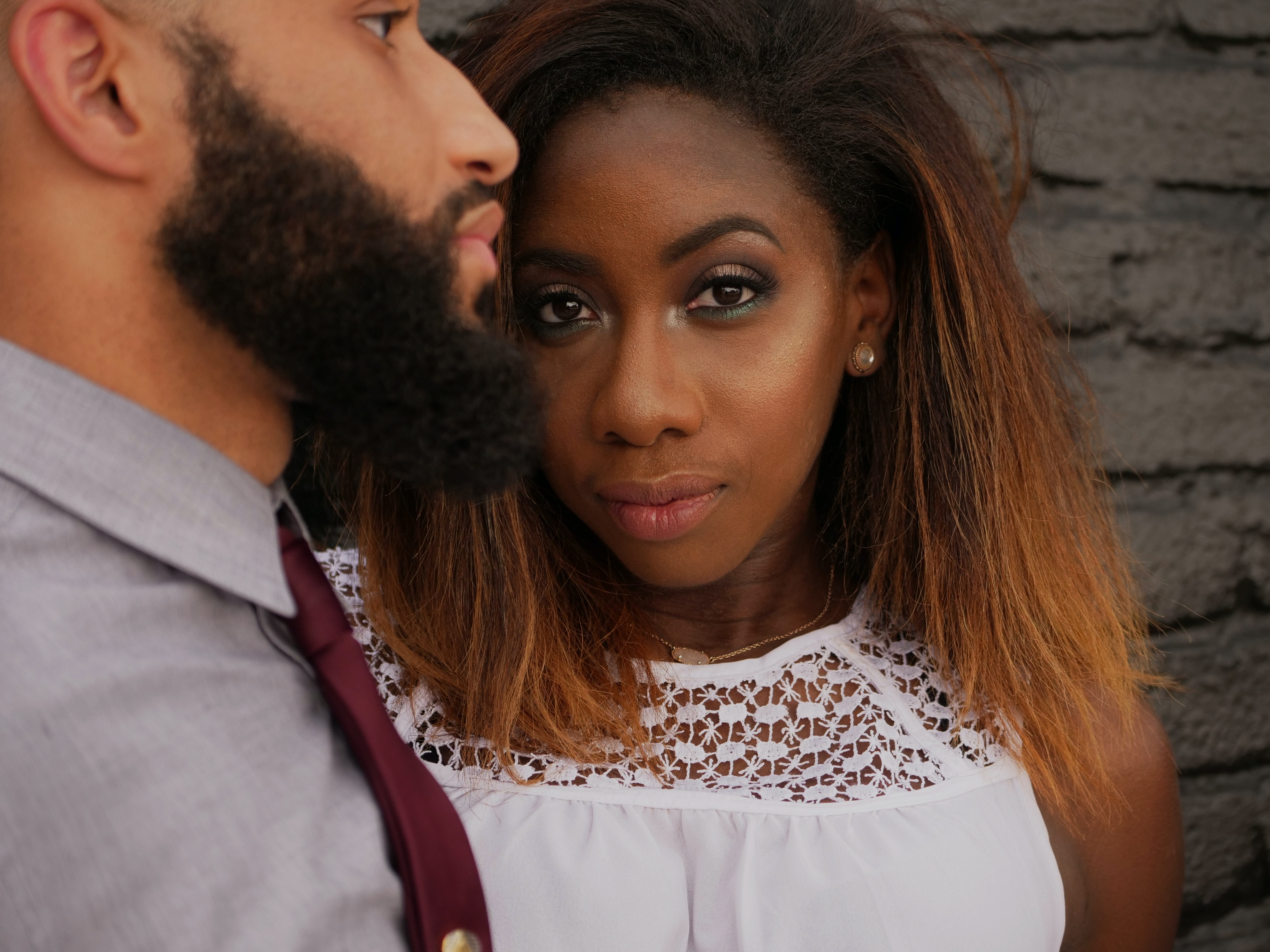 portrait of two people, one looking at the camera